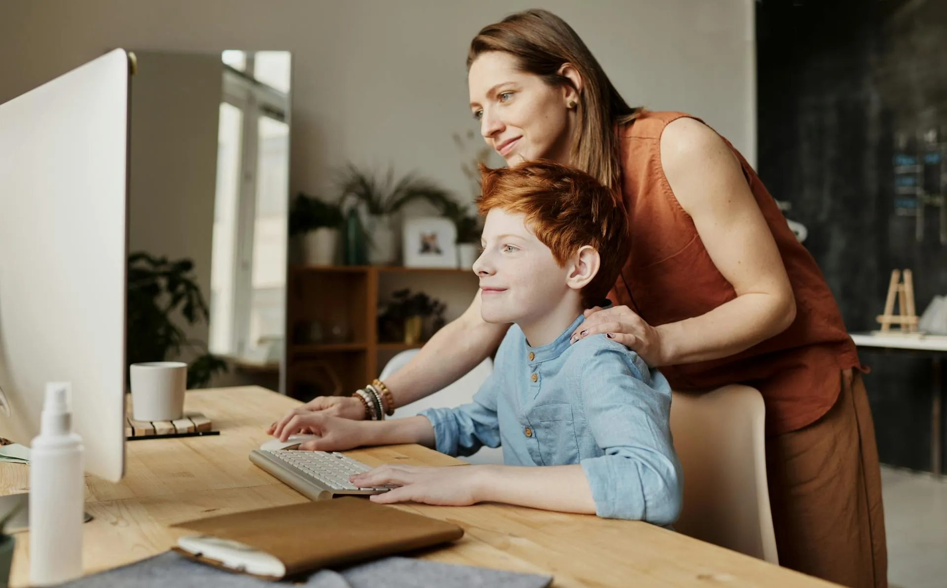 Mother and son using computer together